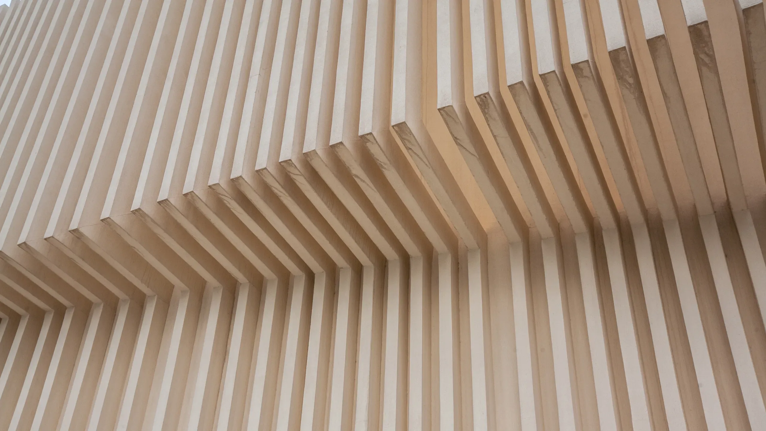 Modern parametric timber design featuring undulating ash-veneered wood slats in a high-end architectural interior.
