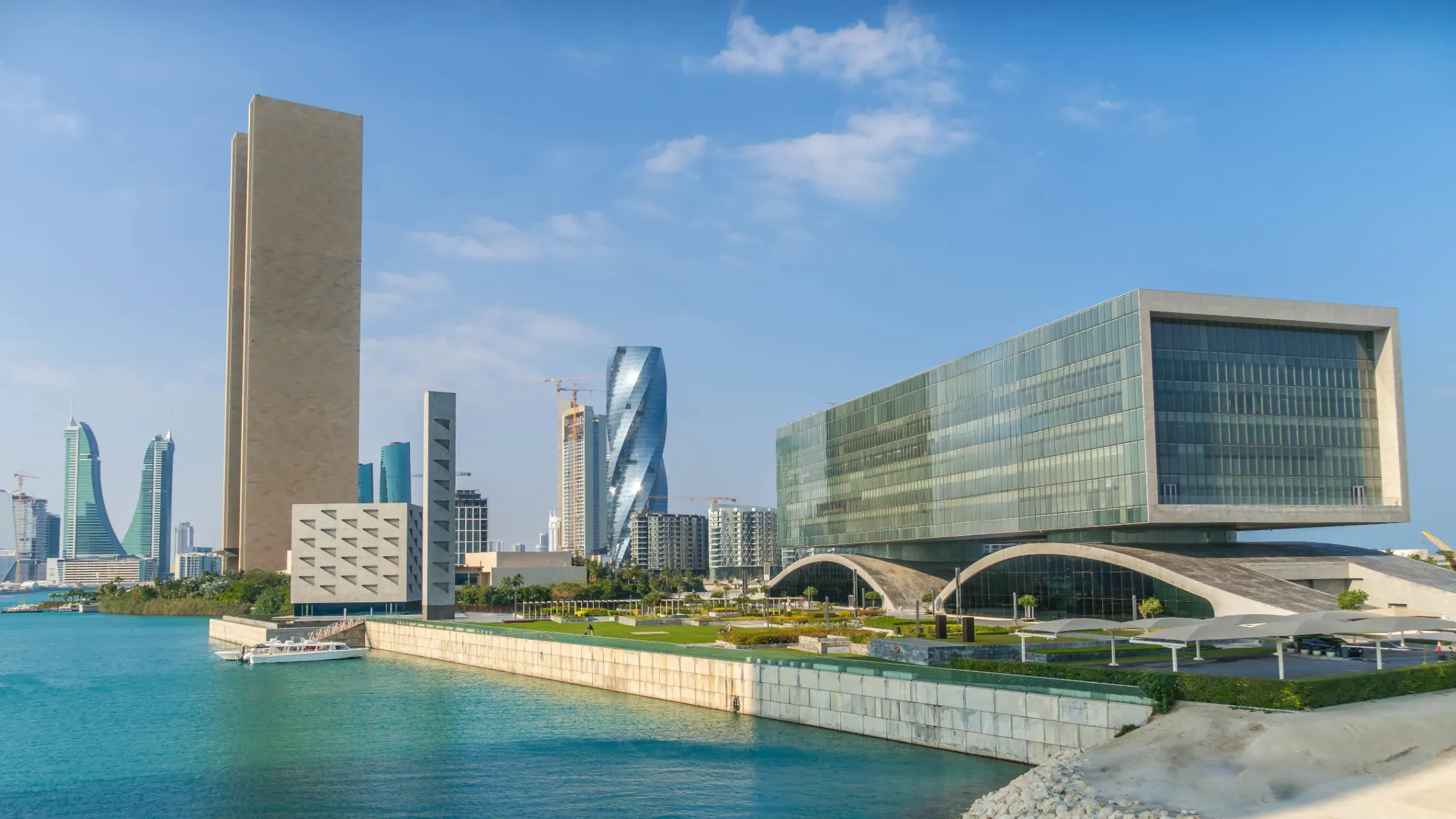 Arcapita Bank Headquarters in Bahrain Bay, featuring a modern rectilinear design atop a sculptural wave-like plinth.