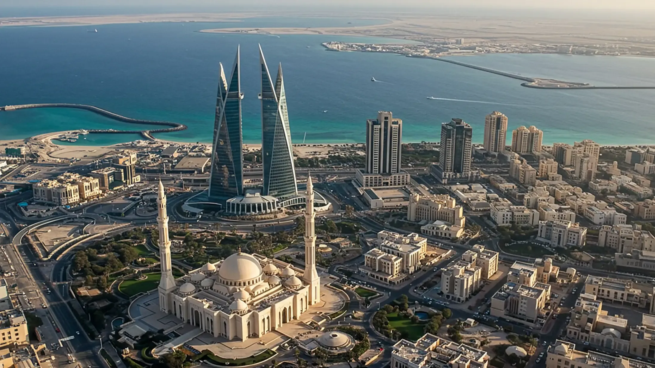 Aerial view of Manama city featuring Al Fateh Grand Mosque in the foreground and the iconic Bahrain World Trade Center towers. 