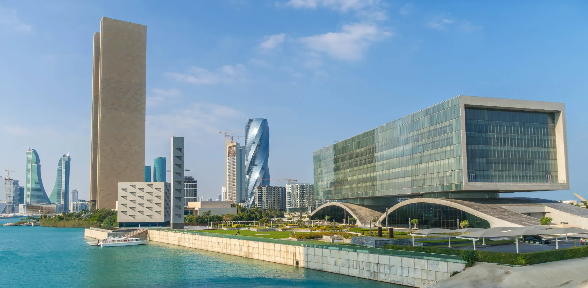 Arcapita Bank Headquarters in Bahrain Bay, featuring a modern rectilinear design atop a sculptural wave-like plinth.